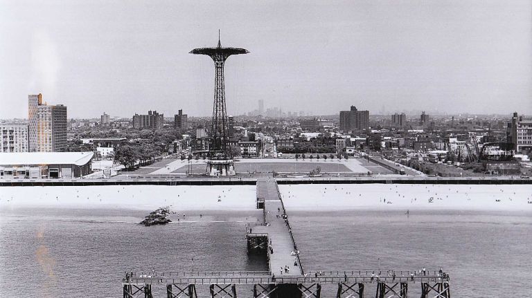 View of a pier and the parachute drop at Coney Island. (June 11, 1987)