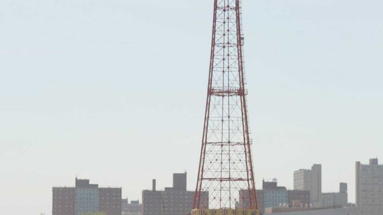 People walk by the old parachute jump towers near the boardwalk as they celebrate Memorial Day by the beach at Coney Island May 26, 2008. Coney Island is in the process of revamping its historic parkland as the city plans development in conjunction with major retail buildings. 