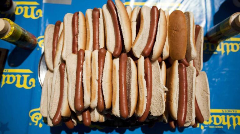 Hot dogs are displayed on stage at the 2010 Nathan's Famous Fourth of July International Hot Dog Eating Contest at the original Nathan's Famous in Coney Island on July 4, 2010. Joey Chestnut won this year's International Federation of Competitive Eating event, eating 54 hot dogs, while his biggest rival Takeru Kobayashi didn't compete due to a contract dispute with Major League Eating. Subsequently, Kobayashi was arrested for attempting to hop a barricade and get on the stage after the event, charges are pending.