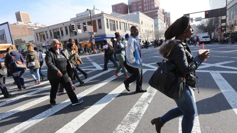 Crossing Frederick Douglass Blvd. at 125th street in Harlem, Wednesday, April 2, 2014.
