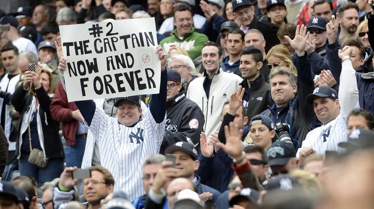 New York Yankees fans cheer for Derek Jeter during the opening ceremonies of the home opener against the Baltimore Orioles at Yankee Stadium on April 7, 2014.