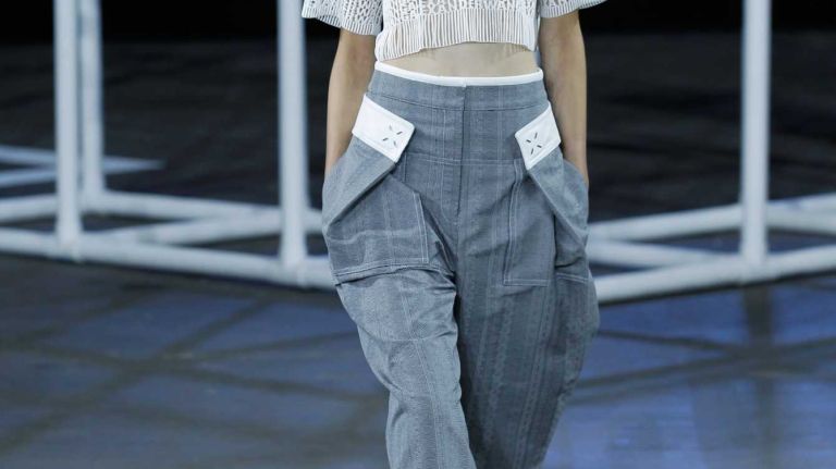 Designer Alexander Wang dares to bare at his spring 2014 fashion show, pairing a cropped sweater with a pair of wide-leg pants -- a fashion-forward style for the season.