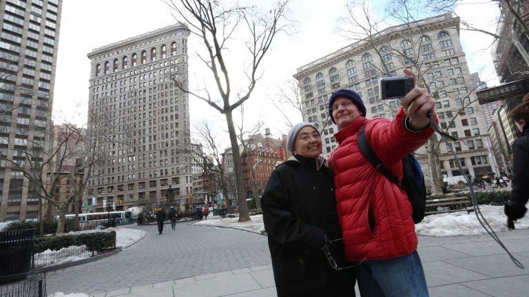Ken and Charlotte Lightell take photos in Madison Square Park on Feb. 24, 2014.