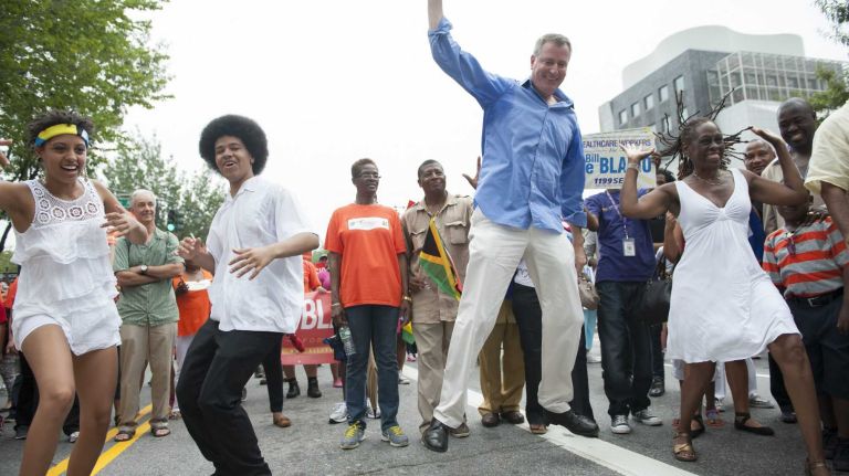 From left: Chiara de Blasio, Dante de Blasio, Bill de Blasio, and his wife Chirlane de Blasio, perform a cheer during the parade in Brooklyn. (Sept. 2, 2013)