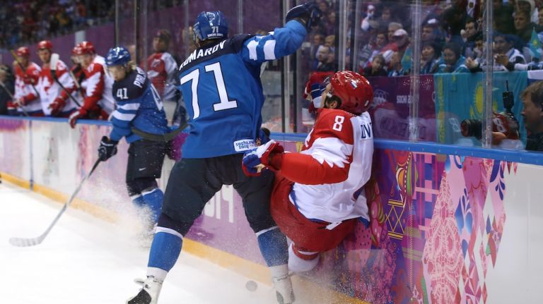 Leo Komarov #71 of Finland checks Alexander Ovechkin #8 of Russia into the boards during the Men's Ice Hockey Quarterfinal Playoff on Day 12 of the 2014 Sochi Winter Olympics at Bolshoy Ice Dome on Wednesday, Feb. 19, 2014.