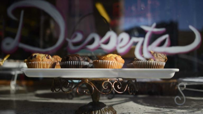 Muffins are displayed in the window of Rudy's Bakery on Seneca Avenue. 