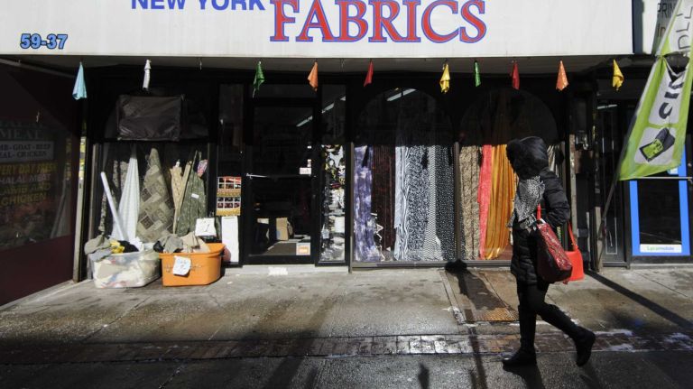 A pedestrian walks along Myrtle Avenue. 