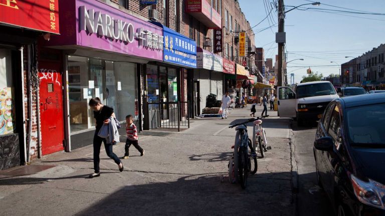 New Yorkers walk along 8th Avenue. 