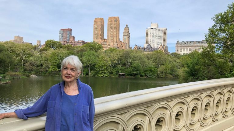 Elizabeth Barlow Rogers, the Central Park Conservancy's first president, stands on the cast-iron Bow Bridge. The bridge dates back to the creation of the park in the 1860s.