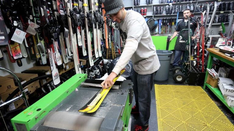 Robert Ottofaro waxes skis at Panda Ski and Sport, a destination for skiing and snowboard gear in Fort Hamilton.
