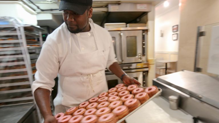 Chris Johnson with tray of Cronuts featuring a mascarpone ganache and rhubarb rose fondant at Dominique Ansel Bakery, at 189 Spring St, on April 14, 2018.