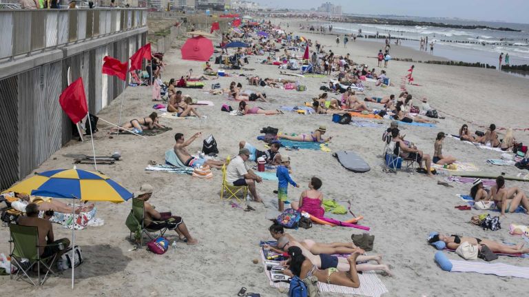 New Yorkers from all over the city catch some sun at Rockaway Beach. 