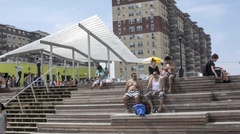Beachgoers can take a break on benches at Rockaway Beach. 