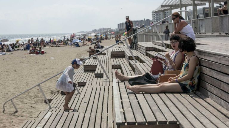 Wooden steps can also serve as lounge chairs at Rockaway Beach.