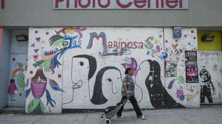 A mural on the rear of a Rite Aid Pharmacy reads 