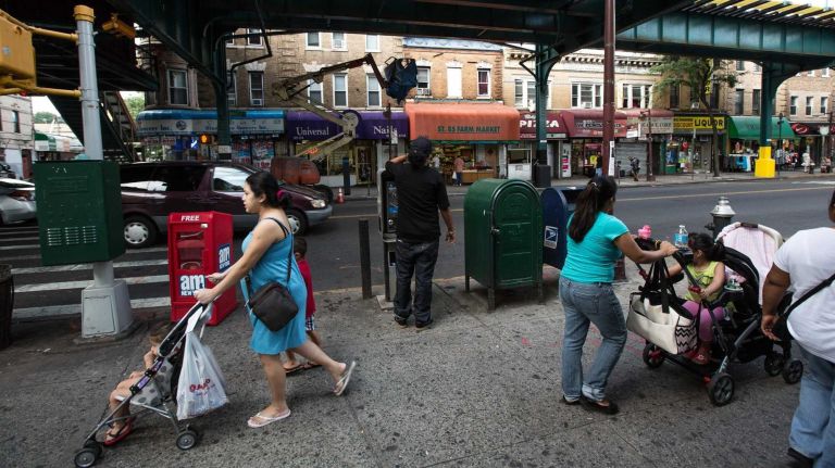 Women push strollers along busy Jamaica Avenue. (Aug. 29, 2013)