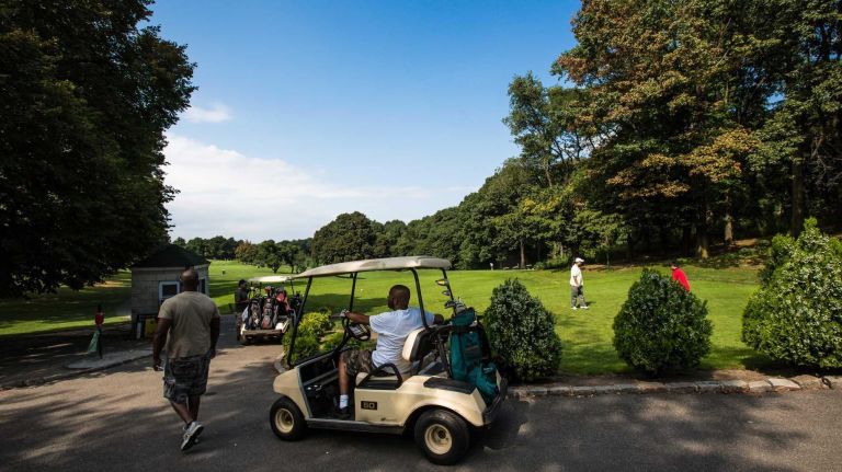 Players arrive in golf carts to tee off at the first hole at Forest Park Golf Course. (Aug. 29, 2013)