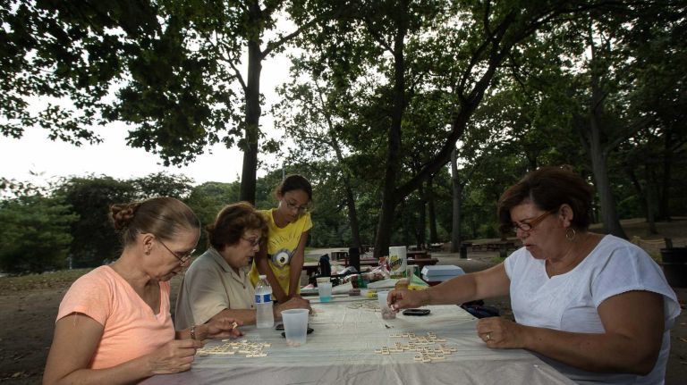 Marta Rodriguiz, Lydia Russo, Samantha Russo and Neyda play a game of Bananagrams in Forest Park. (Aug. 29, 2013) 