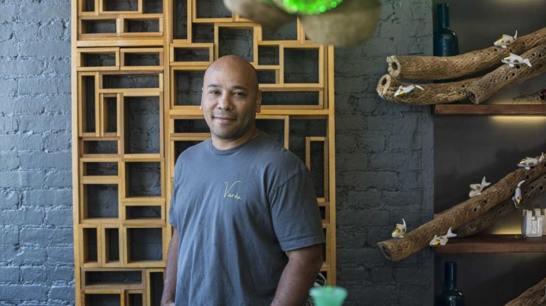 Miguel Gonzalez poses for a photo inside Verde Flowers.