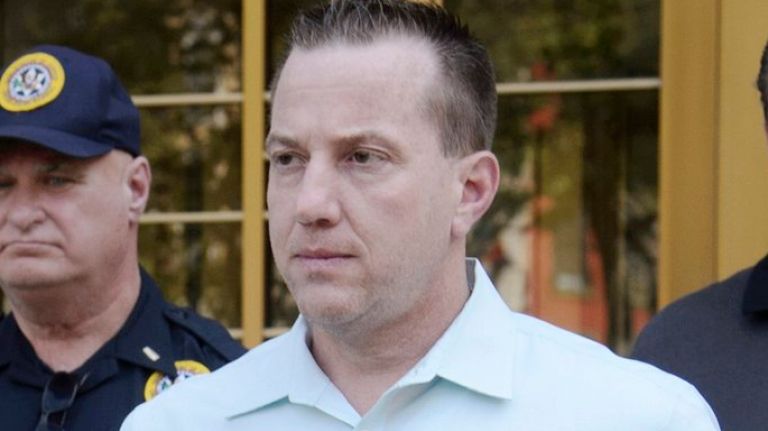 NYPD Deputy Inspector James Grant, left, exits a federal courthouse in Manhattan after being arraigned on Monday, June 20, 2016. Deputy Inspector Grant was charged with accepting bribes in exchange for official acts.