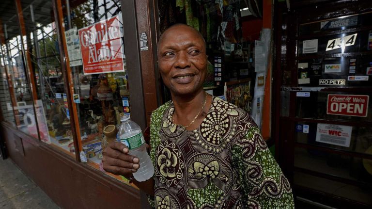Aitna Ogbeide of Nigeria standing in front of his shop OWA Afrikan Market Inc., at 434 Myrtle Ave. (August 10, 2013)