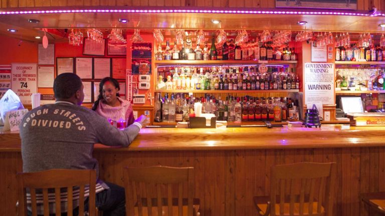 Bartender Amelia Brown speaks with Wesley Sumpton at Windies Restaurant And Bar on Jamaica Ave.