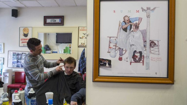 Thomas Foley, an Irish immigrant, gets a haircut at Gavin Barbershop in Woodlawn.
