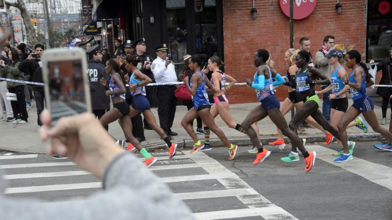 Runners in the professional women's division turn onto Vernon Boulevard in Queens during the 2017 TCS New York City Marathon on Sunday, Nov. 5, 2017.