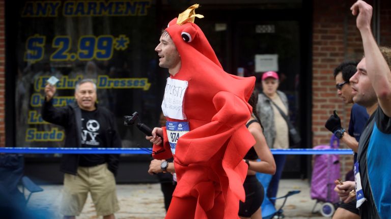 A runner wearing a crab costume runs along 48th Avenue in Queens during the 2017 TCS New York City Marathon on Sunday, Nov. 5, 2017.