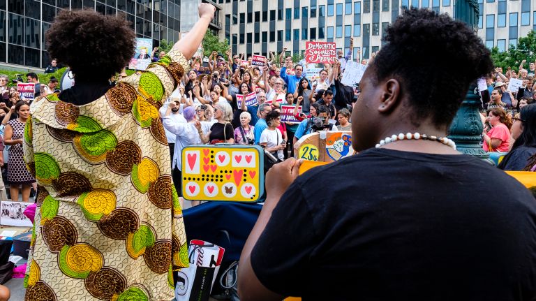 Organizers lead protesters in chants as they demonstrate at Federal Plaza.