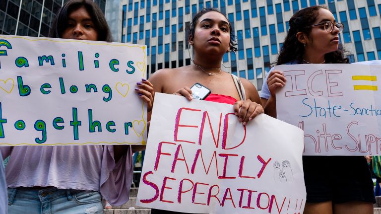 Protesters held signs supporting family reunification. 