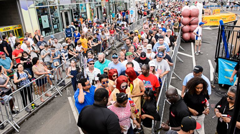 Nathan's Hot Dog Eating Contest 2017: Photos from the Coney Island event 30 Spectators wait in a security line to enter the Nathan's Famous Hot Dog Eating Contest in Coney Island on Tuesday, July 4, 2017.