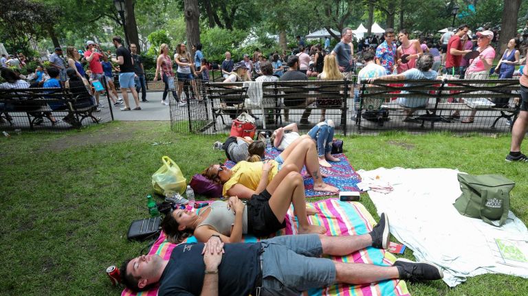 Stomachs full, Mike Bovino of North Massapequa, Monaca Marquez and Nicola Marquez rest on the lawn.