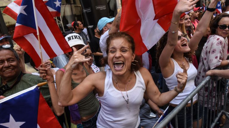 Spectators cheer alongside Fifth Avenue during the Puerto Rican Day Parade in Manhattan on Sunday, June 11, 2017.