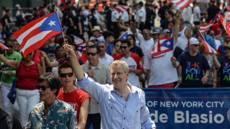 Mayor Bill de Blasio participates in the Puerto Rican Day Parade marching up Fifth Avenue on Sunday, June 11, 2017.