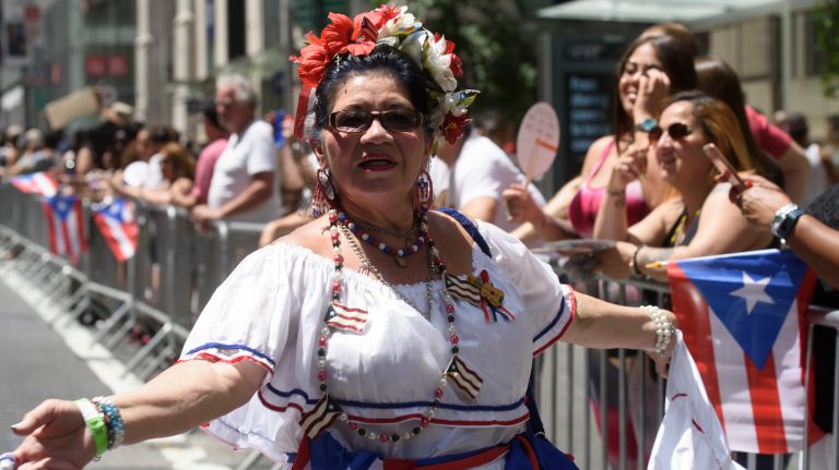 A woman marches and dances down Fifth Avenue during the Puerto Rican Day Parade on Sunday, June 11, 2017. 