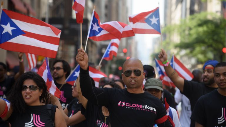 Activists march in the 60th annual Puerto Rican Day Parade in Manhattan on Sunday, June 11, 2017. 