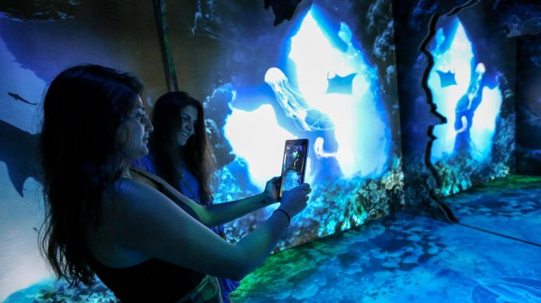 Aparna Avasarala, left, and Nicolette Petrouleas take in the Arcadia Earth exhibit at 718 Broadway in Manhattan on Aug. 28.