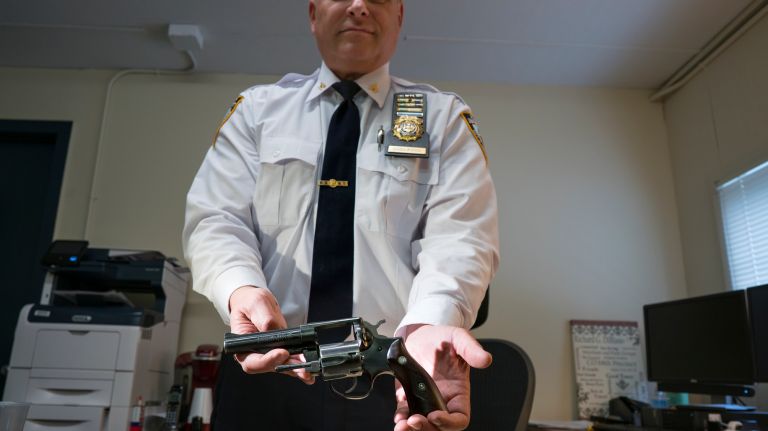 Richard G. DiBlasio Inspector, and Commanding Officer of Firearms and Tactics Sector, shows of his retired service weapon at Rodman's neck gun range in the Bronx on May 30, 2018. The gun was a gift to him from his grandmother at a time when officers had to purchase their own guns.