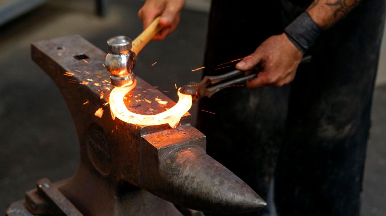 Martinez works to adjust a shoe for Centennial.