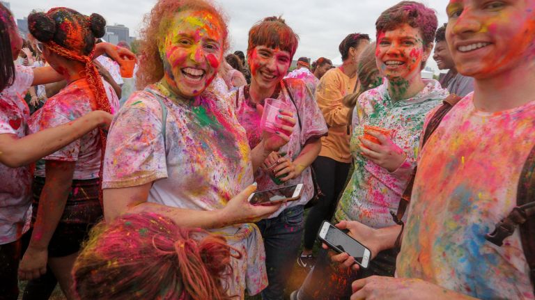 Revelers covered in gulal.