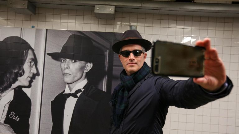 Ed Cabrera stops to take a selfie in the Davie Bowie exhibit.