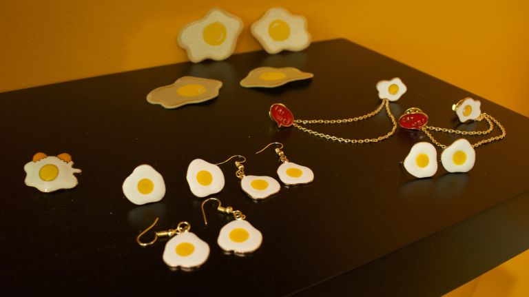 Egg-themed items, like earrings, are available for purchase.