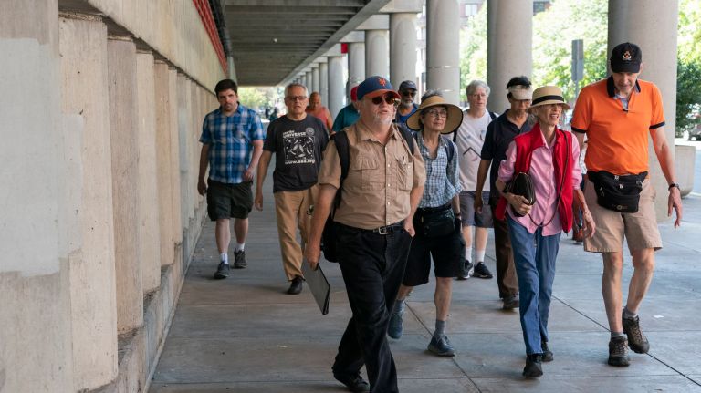 Kevin Walsh, center, guides a group during walking tour of the northern end of Roosevelt Island.