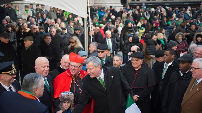 Mayor Bill de Blasio, standing next to Cardinal Timothy Dolan and Police Commissioner James O'Neill, shakes hands with Rep. Peter King in front of St. Patrick's Cathedral.