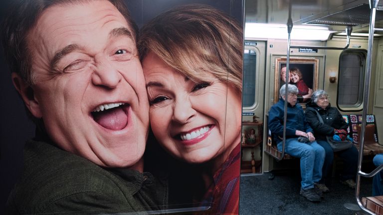 Commuters are greeted by a giant portrait of Roseanne and Dan aboard the 