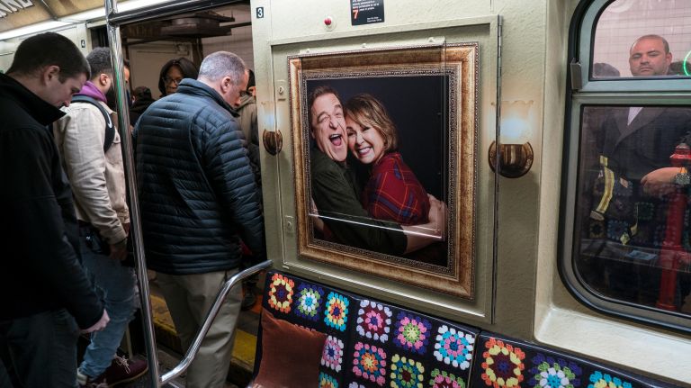 Family portraits line the walls where advertisements and NYC transit maps once hung. 