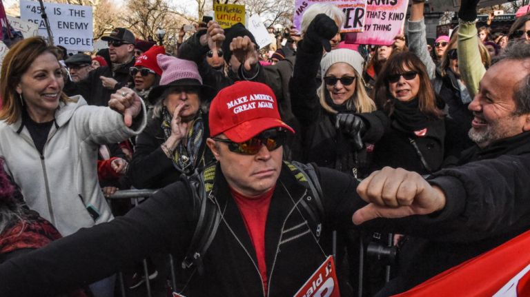 Women's March on NYC: Photos of the 2nd annual demonstration 31 A Trump supporter, met with boos, makes his way through the Women's March in Manhattan on Jan. 20, 2018.
