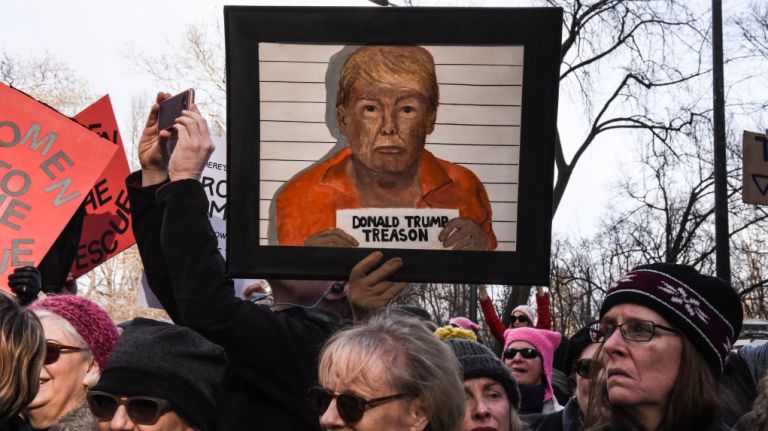 Women's March on NYC: Photos of the 2nd annual demonstration 32 People hold a sign picturing President Donald Trump in a mugshot during the Women's March in Manhattan on Jan. 20, 2018.