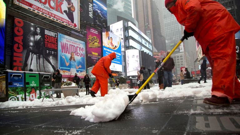 Snow in NYC: Photos from winter 2016-2017 37 Times Square Alliance employees shovel snow off a street in Manhattan's Duffy Square on Tuesday, March 14, 2017.